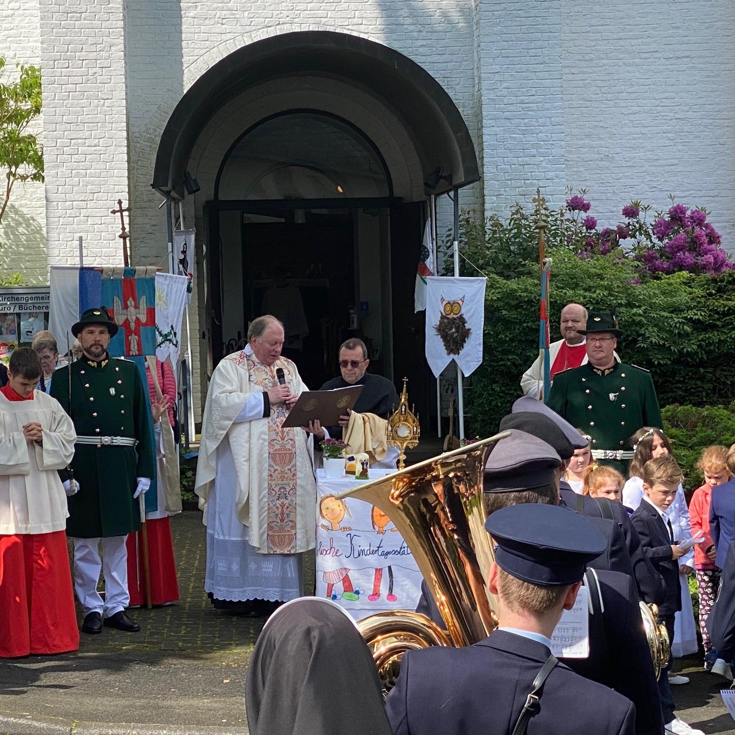 Vor der evangelischen Kirche am Altar von Kindern der Kath. Kita Adolph Kolping endete die kleine  Prozession. Dort wurde mit dem geweihten Brot der feierliche Segen erteilt.